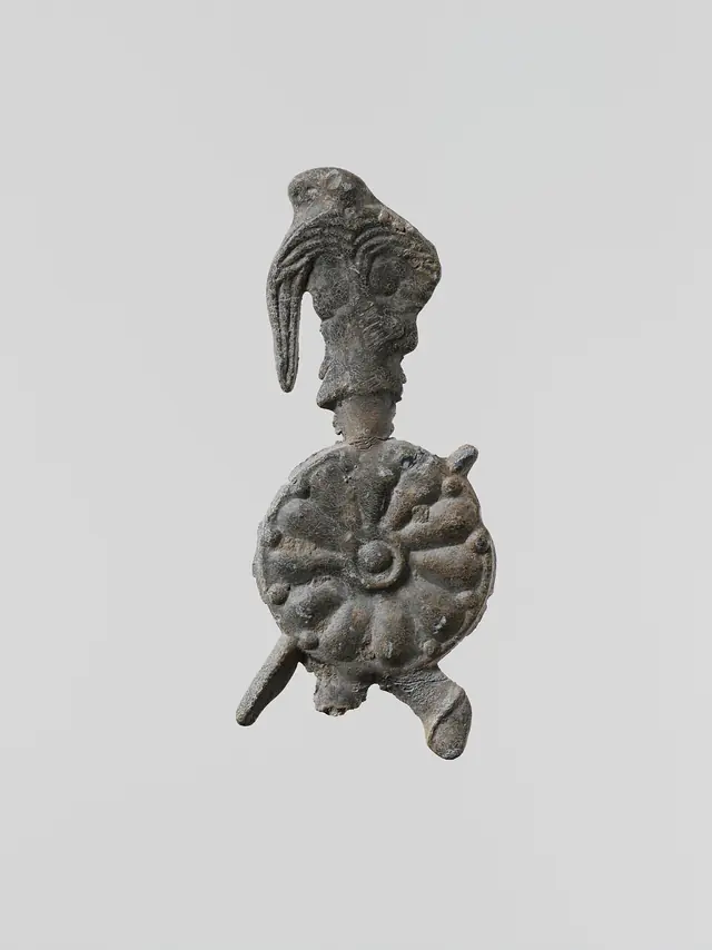 Lead figure of a warrior with a helmet, shield, and spear